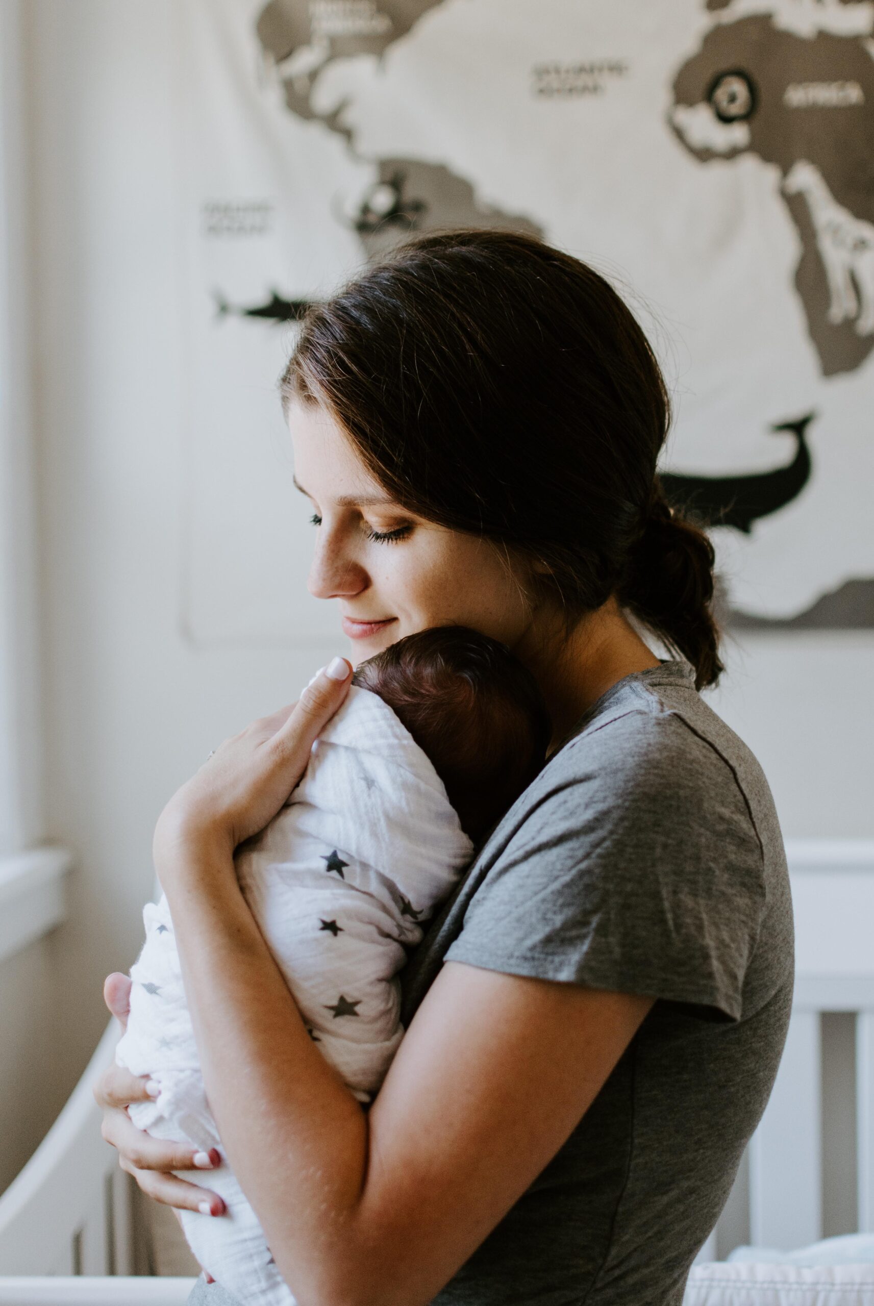 Mom holding infant while warped on a doctor's visit