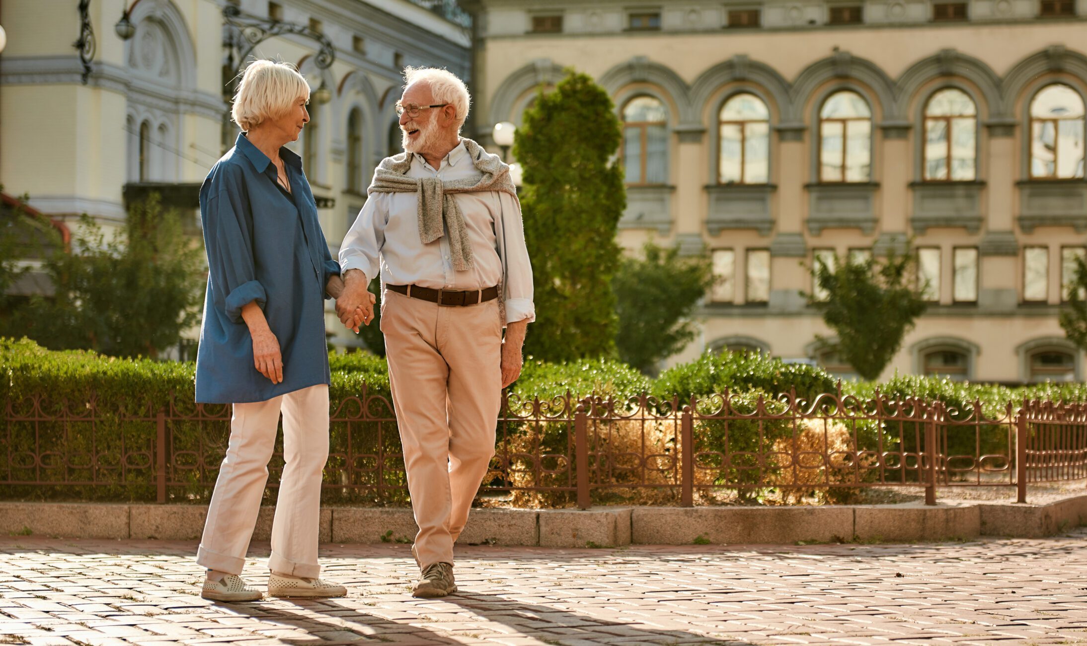 happy elderly couple walking