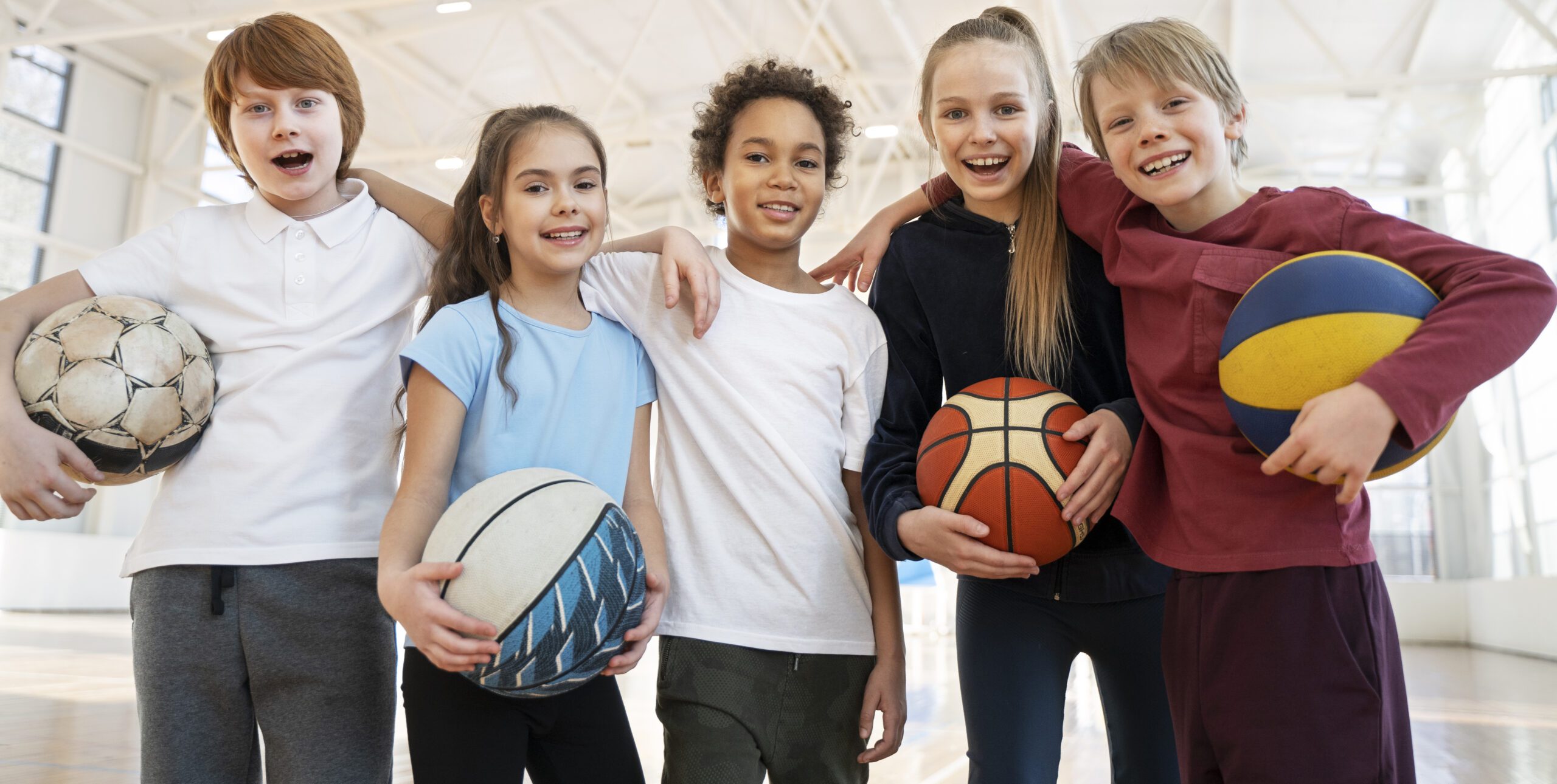 Kids playing resting after playing sports together on a team.