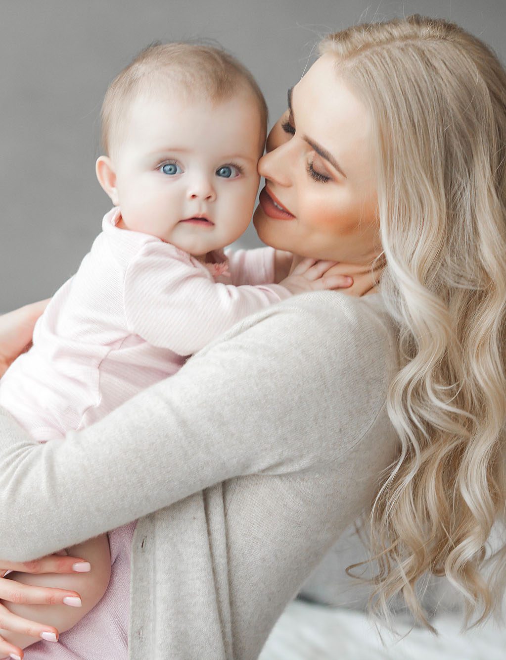 mother holding baby to chest