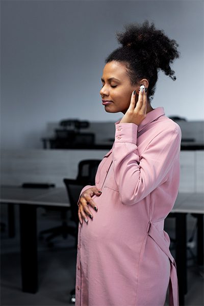 pregnant woman wearing earphones