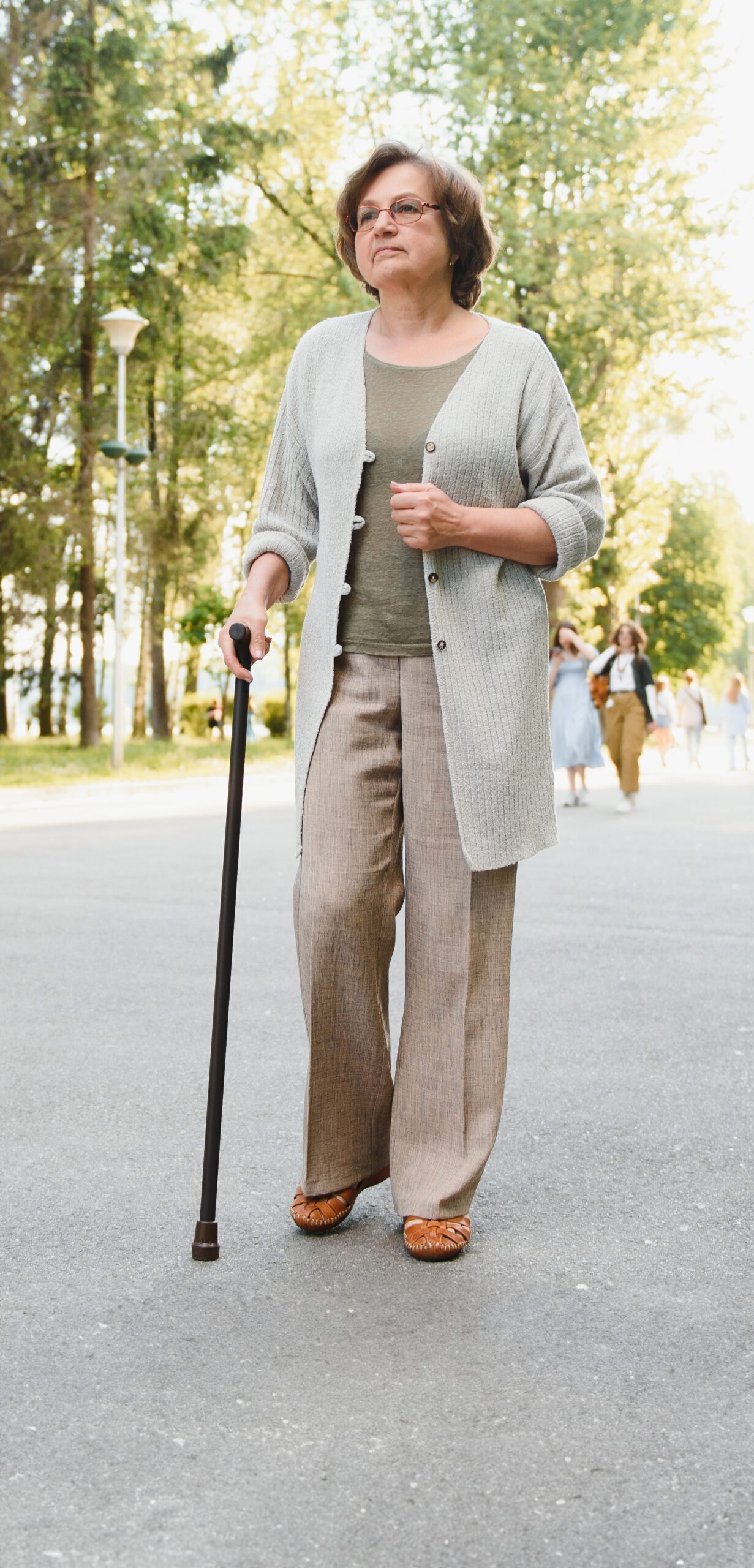 Senior woman walking with walker after fall.